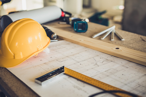 Remodeling plans with hard hat